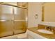 Bathroom with a shower, granite countertop with a white sink, and decorative gold accents at 8044 Rural Retreat Ct, Orlando, FL 32819