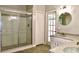 Bright bathroom with glass shower and door leading to backyard at 8044 Rural Retreat Ct, Orlando, FL 32819