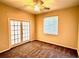 Spacious bedroom showcasing plush carpet, ceiling fan, and French doors at 8044 Rural Retreat Ct, Orlando, FL 32819