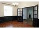 Dining room with dark wood floors, wainscotting, and access to bathroom at 8044 Rural Retreat Ct, Orlando, FL 32819