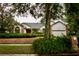 Charming single-story home showcasing a well-manicured lawn, mature trees, and a two-car garage at 8044 Rural Retreat Ct, Orlando, FL 32819