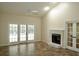 Bright living room featuring neutral walls, fireplace, ceiling fan, and French doors to the backyard at 8044 Rural Retreat Ct, Orlando, FL 32819
