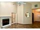 Open living room with tile floors, a cozy fireplace, and a ceiling fan at 8044 Rural Retreat Ct, Orlando, FL 32819