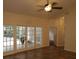 Spacious living room with tile floors, ceiling fan and access to backyard through large French doors at 8044 Rural Retreat Ct, Orlando, FL 32819