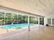 Covered screened-in pool with a jacuzzi and beautiful tall white columns at 8044 Rural Retreat Ct, Orlando, FL 32819