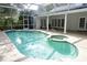 Swimming pool and spa with screened-in lanai in backyard at 8044 Rural Retreat Ct, Orlando, FL 32819