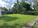 Expansive backyard with lush green grass and a sturdy wooden fence at 907 N Hyer Ave, Orlando, FL 32803