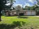 Charming single-story home with a well-manicured lawn and inviting red front door at 907 N Hyer Ave, Orlando, FL 32803