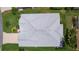 Aerial shot showcasing the home's roof, landscaping, patio, and surrounding neighborhood with mature trees at 924 Figwood Loop, The Villages, FL 32163