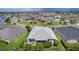 Aerial view of a well-maintained home with lush greenery in a quiet neighborhood at 924 Figwood Loop, The Villages, FL 32163