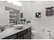 Stylish bathroom featuring a vessel sink, dark cabinetry, unique tilework, and modern fixtures at 924 Figwood Loop, The Villages, FL 32163