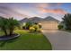 Charming front yard showcasing verdant landscaping, ornamental trees, and a well-maintained lawn leading up to a gray home at 924 Figwood Loop, The Villages, FL 32163