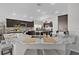 Elegant kitchen with a marble-topped bar, dark cabinetry, stainless appliances, and a seamless open layout at 924 Figwood Loop, The Villages, FL 32163