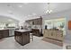 Well-equipped kitchen with dark cabinetry, stainless steel appliances, a center island and a view to the breakfast room at 924 Figwood Loop, The Villages, FL 32163