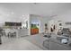 Open-concept living room seamlessly connects to the kitchen, featuring a neutral palette and modern furnishings at 924 Figwood Loop, The Villages, FL 32163