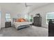 Main bedroom with vaulted ceilings, a ceiling fan, neutral decor, and ample natural light from multiple windows at 924 Figwood Loop, The Villages, FL 32163