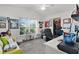 Well-lit home office with a large window, desk space, comfortable seating, and ample storage at 924 Figwood Loop, The Villages, FL 32163