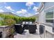 Outdoor patio boasts a comfortable seating area with a gas fire pit, grill, and lush, manicured greenery at 924 Figwood Loop, The Villages, FL 32163