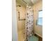 A shot of the stand-up shower with grab bars and a shower curtain at 103 Poinsettia Cv, Leesburg, FL 34748