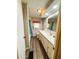 A bathroom is shown with a single sink, commode and shower-tub combination at 103 Poinsettia Cv, Leesburg, FL 34748