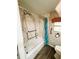 A full shot of the shower-tub combination with the toilet and grab bars present at 103 Poinsettia Cv, Leesburg, FL 34748