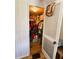 A closet is shown with bifold doors that are off-white and the closet is full at 103 Poinsettia Cv, Leesburg, FL 34748
