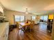 Comfortable dining room with hard wood floors and decorative lighting at 103 Poinsettia Cv, Leesburg, FL 34748