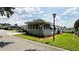 Well-maintained single-story home with green lawn, mulched beds, and a corner view at 103 Poinsettia Cv, Leesburg, FL 34748