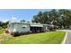 Charming single-story home with awning and well-maintained lawn at 103 Poinsettia Cv, Leesburg, FL 34748