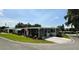 Inviting single-story home with an American flag and a well-kept lawn at 103 Poinsettia Cv, Leesburg, FL 34748