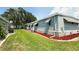 Well-maintained single-story home with brick foundation, mulched beds, and manicured lawn at 103 Poinsettia Cv, Leesburg, FL 34748