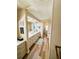 A shot of the hallway shows the entrance to the bathroom and hard floors at 103 Poinsettia Cv, Leesburg, FL 34748