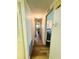 Hallway featuring wood flooring, closet, and access to bedroom at 103 Poinsettia Cv, Leesburg, FL 34748