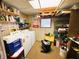 Bright laundry room with front-load washer and dryer, shelving, and good storage capacity at 103 Poinsettia Cv, Leesburg, FL 34748