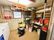 Bright laundry room with front-load washer and dryer, storage, shelving, and workbench at 103 Poinsettia Cv, Leesburg, FL 34748
