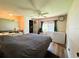 Cozy main bedroom with wood floors, ceiling fan, and large window at 103 Poinsettia Cv, Leesburg, FL 34748