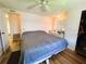 Main bedroom featuring wood floors, ceiling fan, and ample closet space at 103 Poinsettia Cv, Leesburg, FL 34748