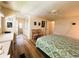 A full view of the main bedroom is shown with hard floors and a ceiling fan at 103 Poinsettia Cv, Leesburg, FL 34748
