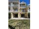 Beautiful rear exterior featuring a patio area with lawn and elegant architectural details at 1310 Seven Eagles Ct # 102, Reunion, FL 34747