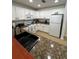 Functional kitchen featuring modern white cabinets, sleek black fixtures, and ample counter space at 1310 Seven Eagles Ct # 102, Reunion, FL 34747
