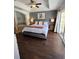Relaxing main bedroom featuring a luxurious bed, en-suite bathroom, and sliding doors to the outside at 1310 Seven Eagles Ct # 102, Reunion, FL 34747