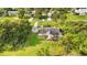 Aerial view of the single-story home showcasing a screened pool, fenced yard, and mature trees at 1330 Englewood Dr, St Cloud, FL 34772
