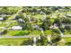 Aerial view showcasing a home with large front lawn and mature trees in a residential area at 1330 Englewood Dr, St Cloud, FL 34772