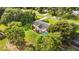 Aerial view of home featuring a backyard screened pool, surrounded by mature trees and lush landscaping at 1330 Englewood Dr, St Cloud, FL 34772
