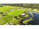 Overhead shot showcases a verdant athletic field, a lake, and a walking path, perfect for outdoor recreation at 1330 Englewood Dr, St Cloud, FL 34772