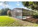 A screened-in pool and lush yard creates an inviting outdoor space perfect for relaxation and entertainment at 1330 Englewood Dr, St Cloud, FL 34772