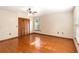 Bright bedroom features hardwood floors, a ceiling fan, and a window with natural light at 1330 Englewood Dr, St Cloud, FL 34772