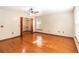Bedroom featuring hardwood floors, neutral walls, closet, and natural light from a window at 1330 Englewood Dr, St Cloud, FL 34772