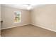 This bedroom features neutral walls, carpet, and a window letting in natural light at 1330 Englewood Dr, St Cloud, FL 34772