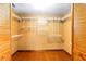 Walk-in closet with custom shelving and wooden floor at 1330 Englewood Dr, St Cloud, FL 34772